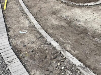 Manchester Tarmac Driveway With A Featured Gravel Area With Black Ice Gravel With A Border And Circle For Planting services