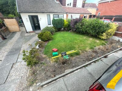 Professional Tarmac Driveway With A Featured Gravel Area With Black Ice Gravel With A Border And Circle For Planting in Manchester