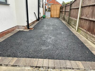 Manchester Tarmac Driveway With A Featured Gravel Area With Black Ice Gravel With A Border And Circle For Planting services