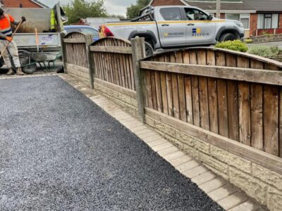 Licenced Manchester Tarmac Driveway With A Featured Gravel Area With Black Ice Gravel With A Border And Circle For Planting