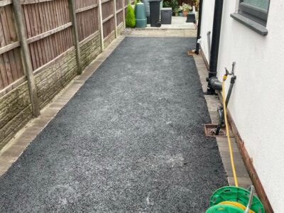 Licenced Manchester Tarmac Driveway With A Featured Gravel Area With Black Ice Gravel With A Border And Circle For Planting
