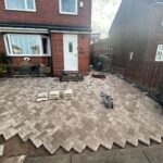 Herringbone block paving being laid on a front driveway