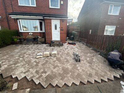 Herringbone block paving being laid on a front driveway
